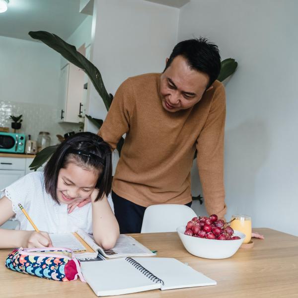 Father and daughter working on homework