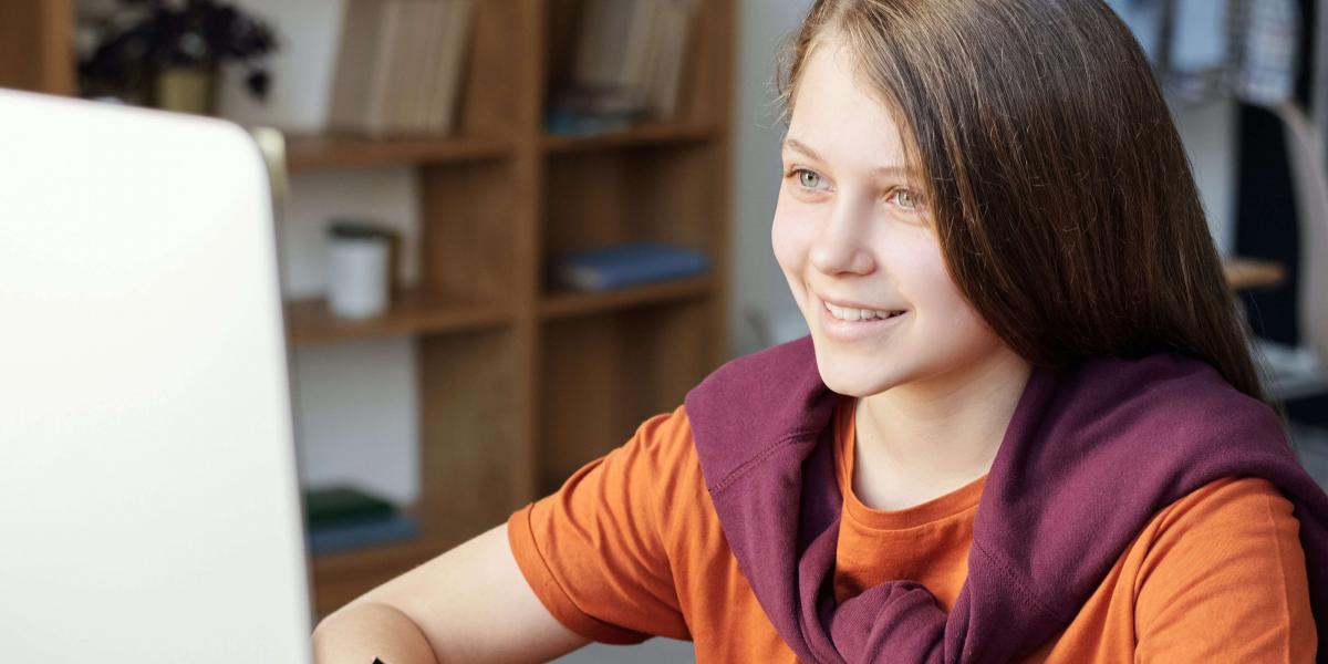 A middle school student engages in classwork at a computer