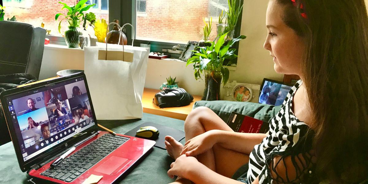 elementary girl working with online classmates via her laptop