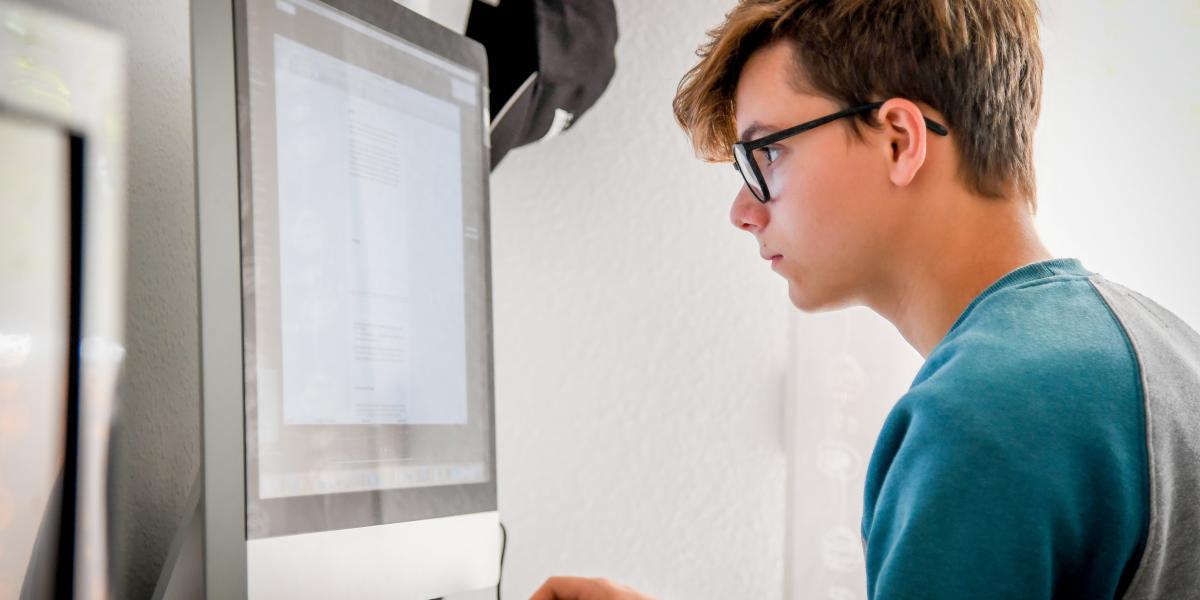 high school cyber security student working on computer